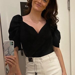 Express bodysuit with puff sleeves.